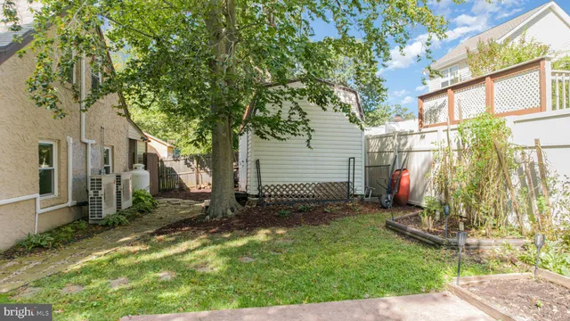 a aerial view of a house with a yard and a large tree