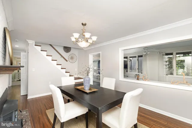 a living room with furniture a clock and a fireplace