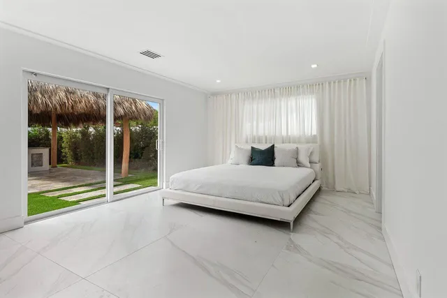 a bedroom with a large bed and a large window