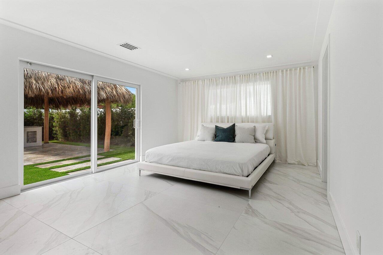 902 Southwest 27th Place Boynton Beach, FL 33435 - Photo 15 of 52 a bedroom with a large bed and a large window