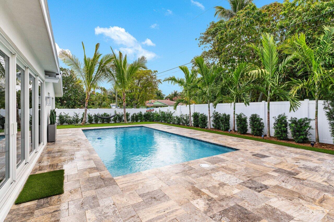 902 Southwest 27th Place Boynton Beach, FL 33435 - Photo 27 of 52 a view of a swimming pool with a patio