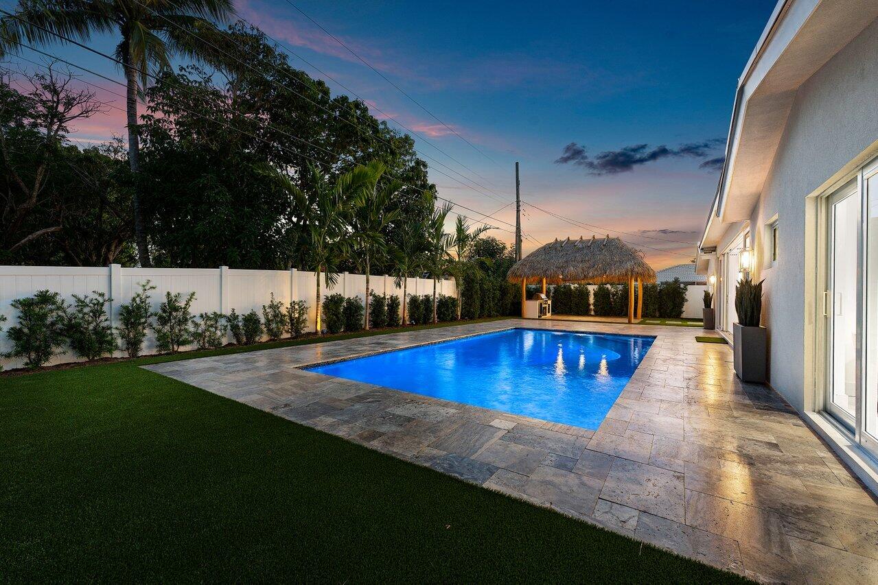 902 Southwest 27th Place Boynton Beach, FL 33435 - Photo 31 of 52 a view of a swimming pool with an outdoor seating