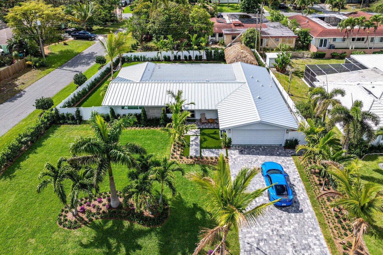 902 Southwest 27th Place Boynton Beach, FL 33435 - Photo 45 of 52 an aerial view of a house with a yard potted plants and large tree