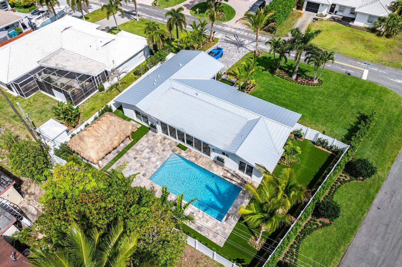 902 Southwest 27th Place Boynton Beach, FL 33435 - Photo 46 of 52 an aerial view of a house with a garden and swimming pool