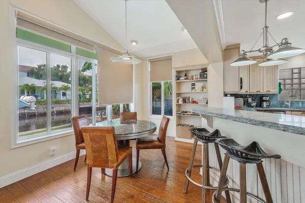 a view of a dining room with furniture window and wooden floor