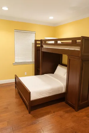 a bed sitting in a bedroom next to a window