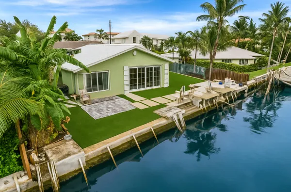 a view of a house with backyard porch and sitting area
