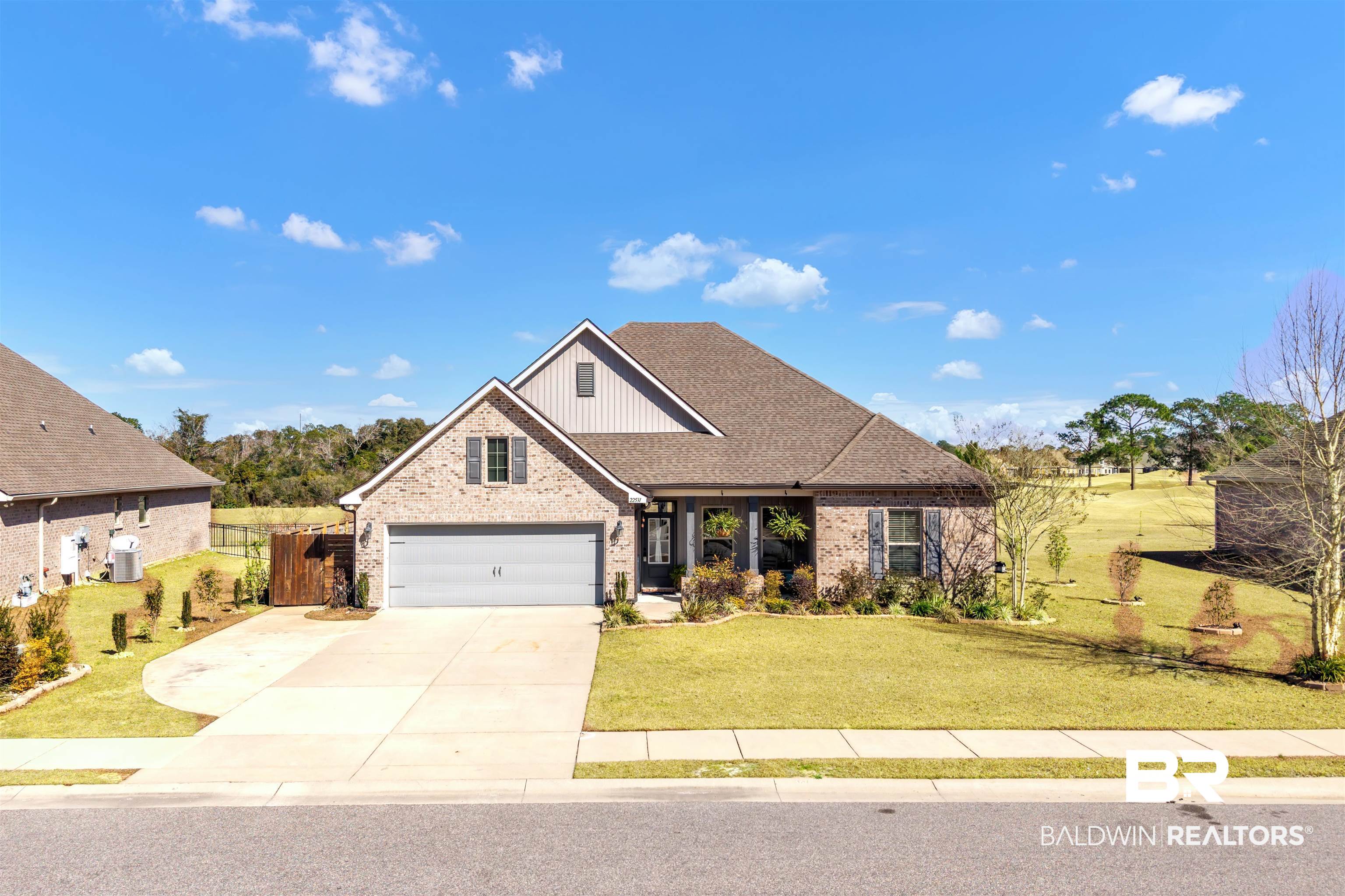 22531 Putter Lane Foley, AL 36535 - Photo 42 of 43 View of front of house with brick siding, a shingled roof, concrete driveway, and board and batten siding
