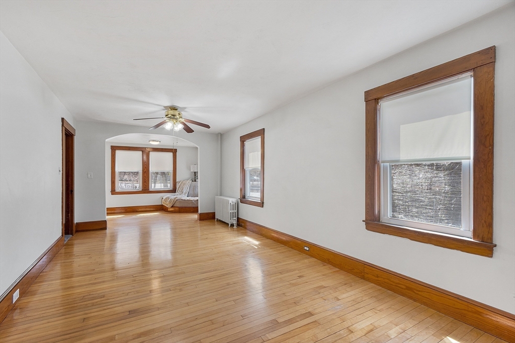48 Mill Street Maynard, MA 01754 - Photo 19 of 31 a view of an empty room with a window and wooden floor