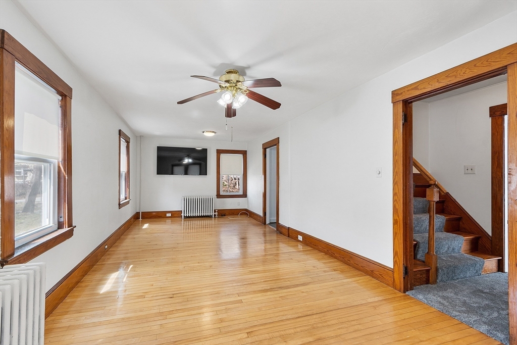 48 Mill Street Maynard, MA 01754 - Photo 20 of 31 a view of an empty room with window and wooden floor