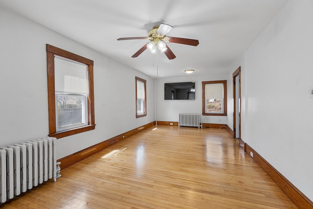 48 Mill Street Maynard, MA 01754 - Photo 21 of 31 a view of an empty room with window and wooden floor