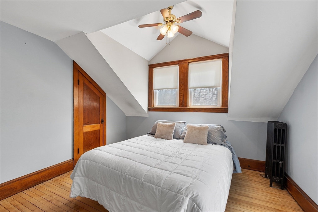 48 Mill Street Maynard, MA 01754 - Photo 22 of 31 a bedroom with a large bed and a chandelier