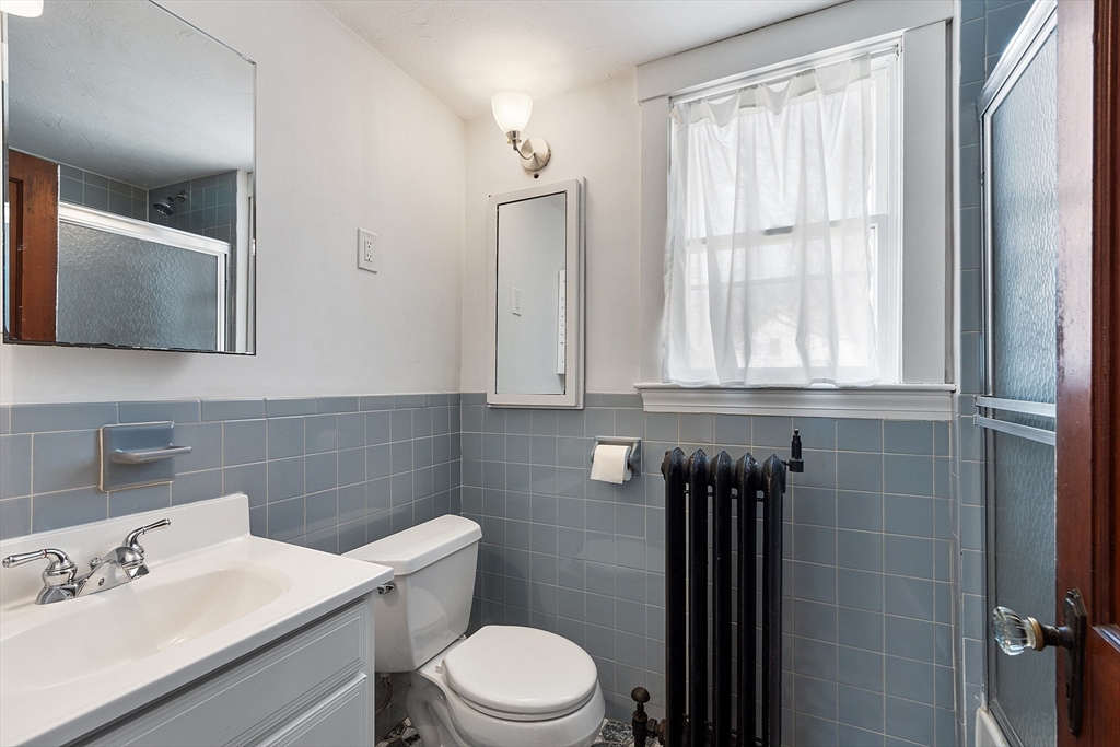 48 Mill Street Maynard, MA 01754 - Photo 25 of 31 a bathroom with a sink a toilet and window