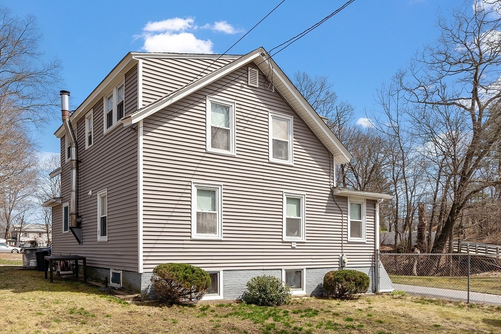 48 Mill Street Maynard, MA 01754 - Photo 3 of 31 a front view of a house with a yard