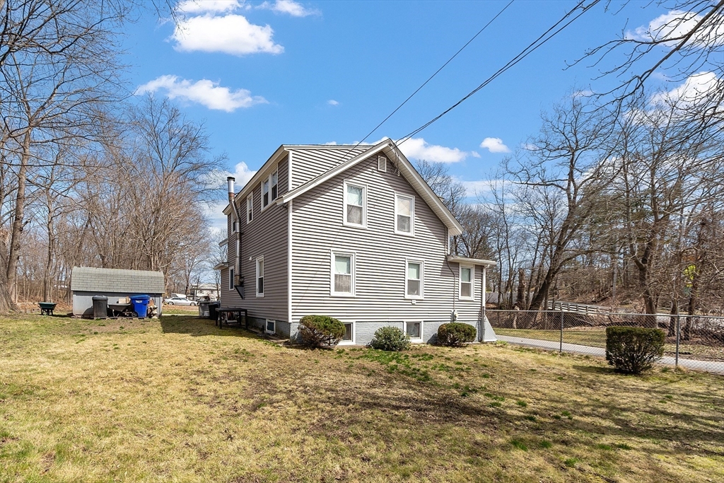 48 Mill Street Maynard, MA 01754 - Photo 4 of 31 a front view of a house with a yard