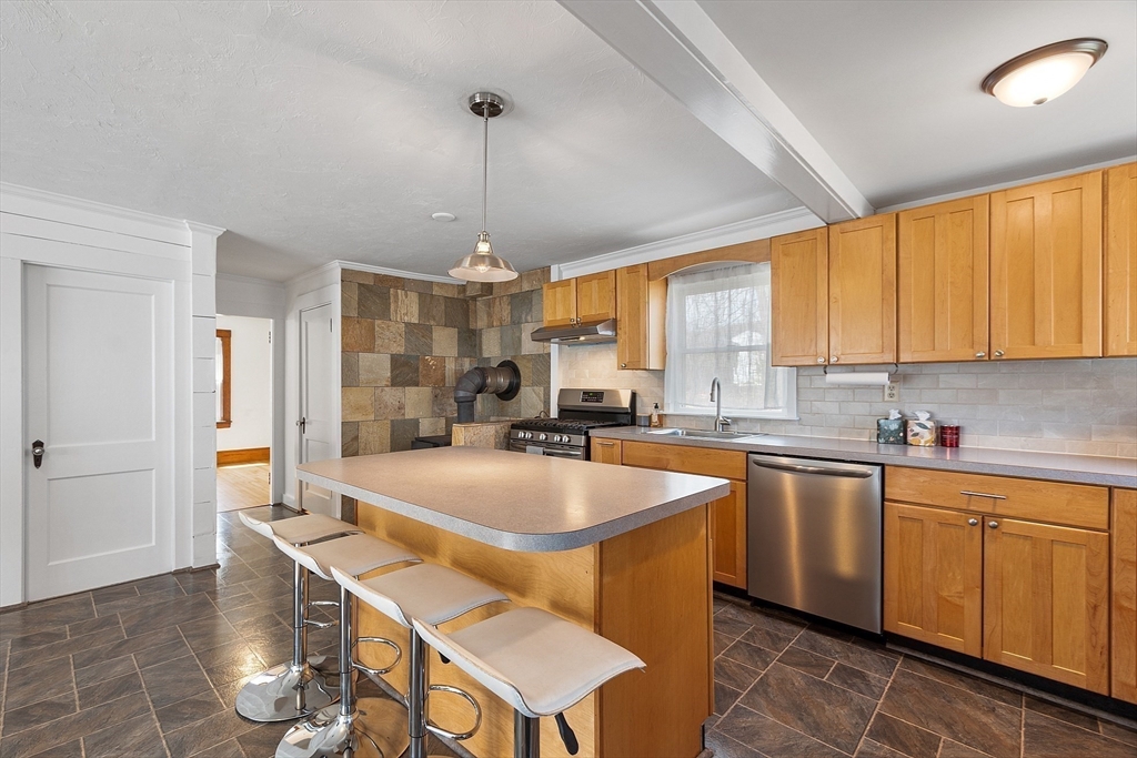 48 Mill Street Maynard, MA 01754 - Photo 6 of 31 a large kitchen with a table and chairs in it