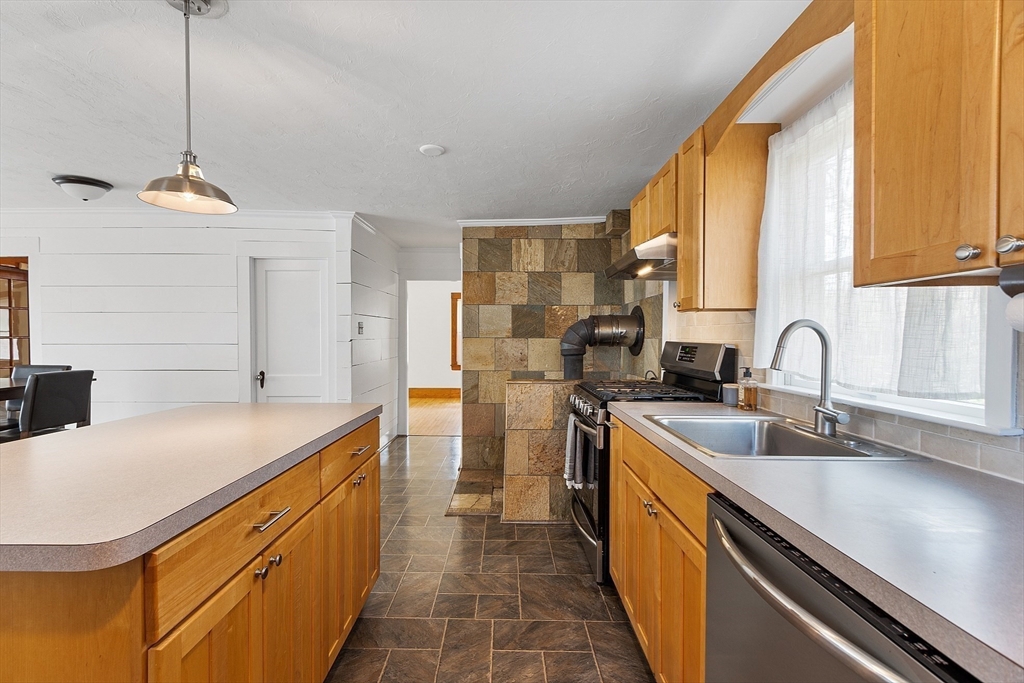 48 Mill Street Maynard, MA 01754 - Photo 7 of 31 a kitchen with stainless steel appliances granite countertop a sink a stove and a refrigerator