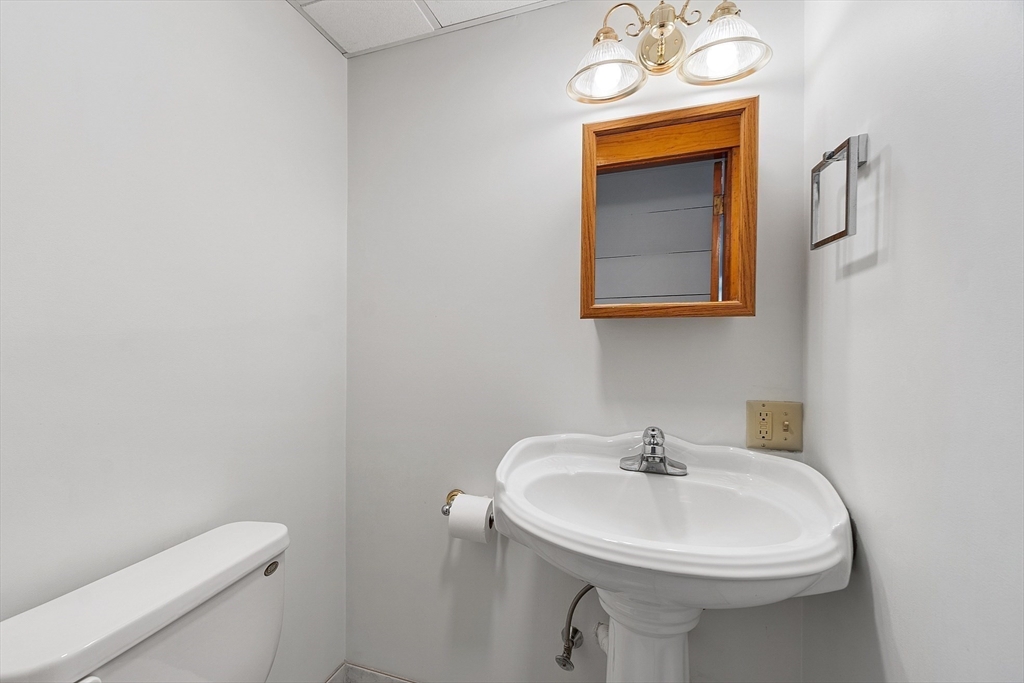 48 Mill Street Maynard, MA 01754 - Photo 8 of 31 a bathroom with a sink a toilet and mirror