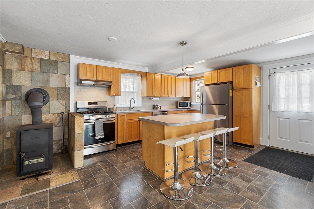 48 Mill Street Maynard, MA 01754 - Photo 10 of 31 a kitchen with stainless steel appliances granite countertop a stove refrigerator and cabinets