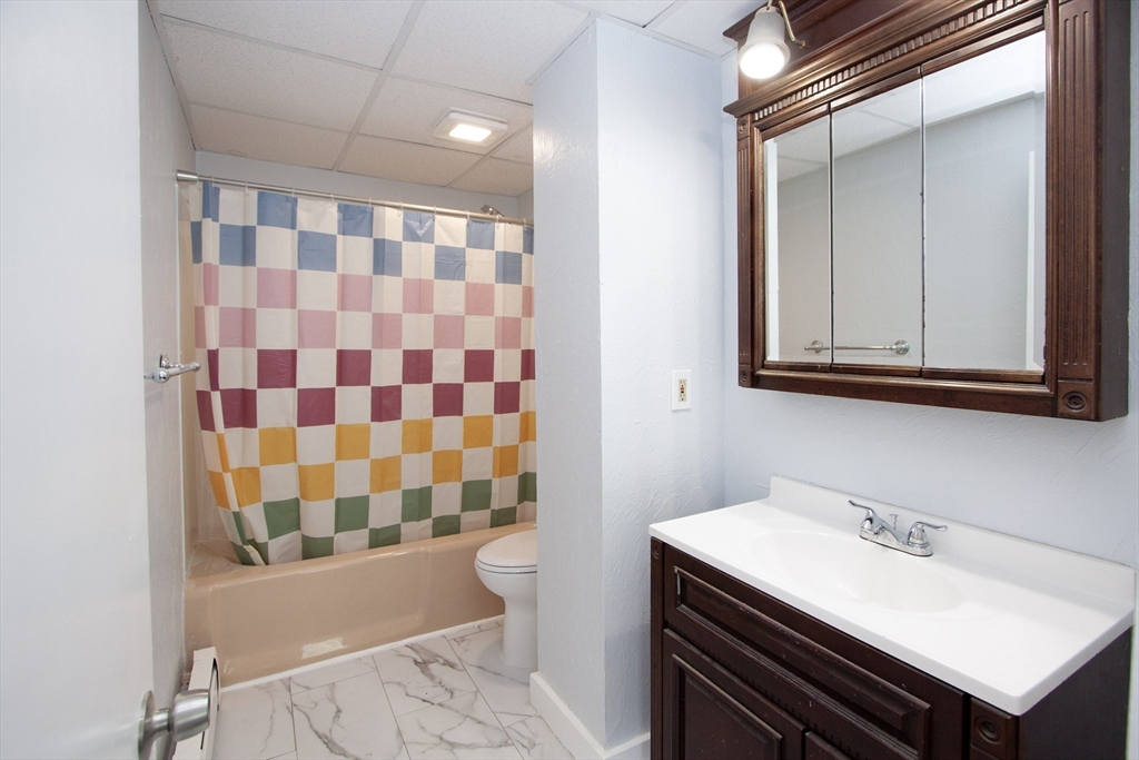66 Cutler Street Worcester, MA 01604 - Photo 6 of 27 a bathroom with a sink a toilet a mirror and shower