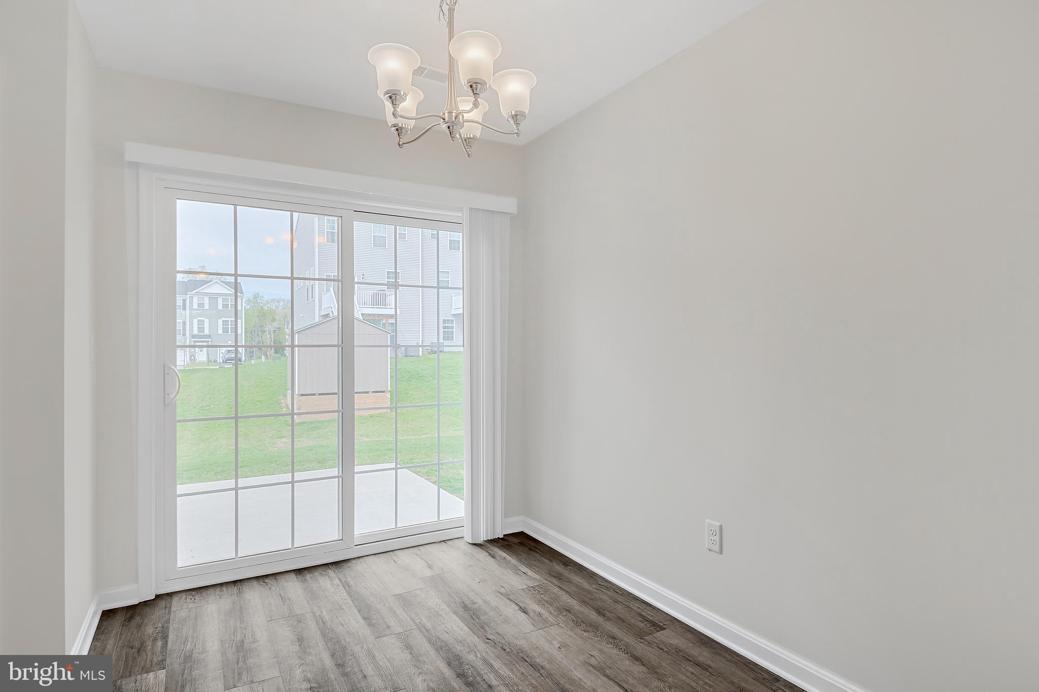 230 Sienna Lane Red Lion, PA 17356 - Photo 10 of 22 a view of an empty room with wooden floor and a window