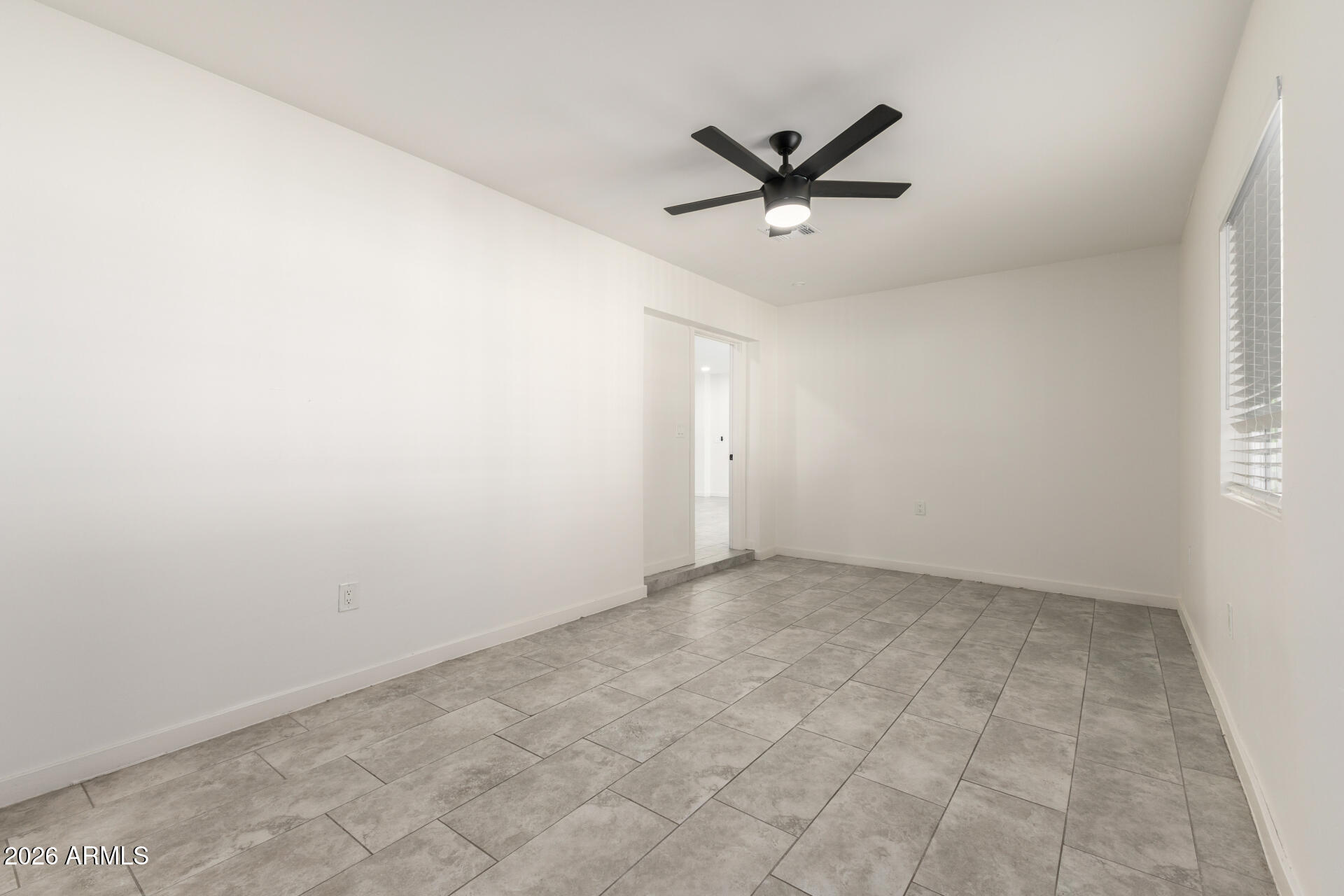 1912 West Roma Avenue Phoenix, AZ 85015 - Photo 15 of 25 an empty room with a window and a fan