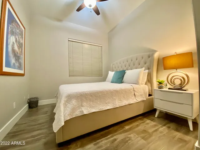 a bedroom with a bed and a night stand