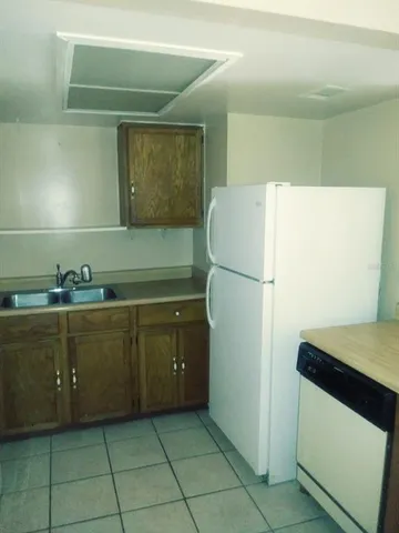 a kitchen with a refrigerator and a cabinets