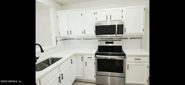 a kitchen with a stove and a microwave