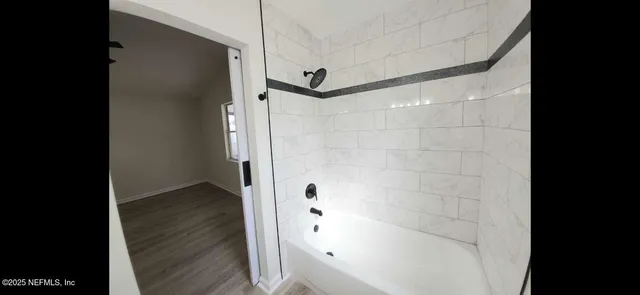 a bathroom with a shower and a glass door
