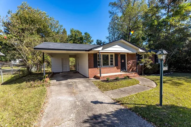 a view of a house with backyard porch and sitting area