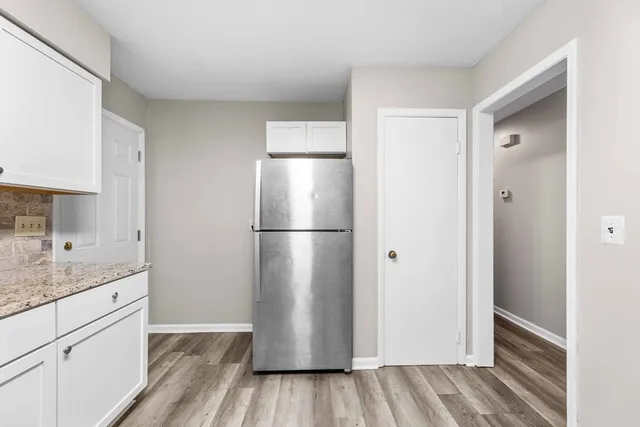 a kitchen with a refrigerator and a sink
