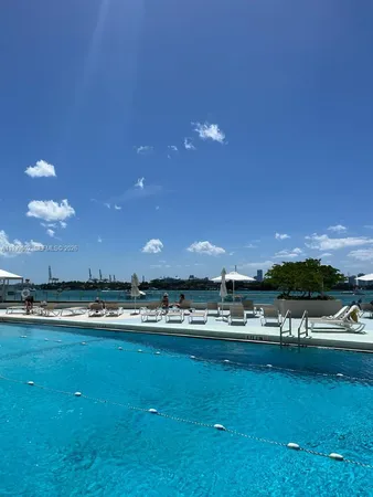 a view of a swimming pool and a yard