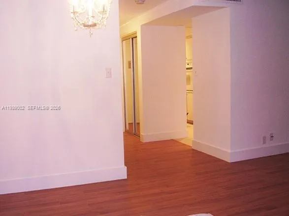 an empty room with wooden floor