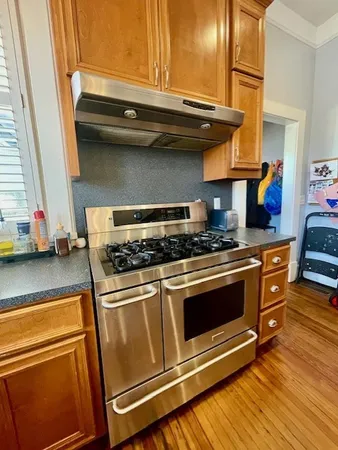 a stove top oven sitting inside of a kitchen