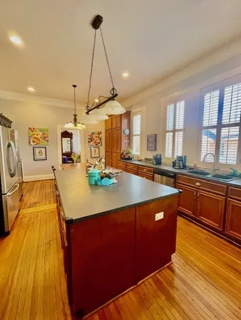 a kitchen with stainless steel appliances granite countertop sink stove top oven and cabinets