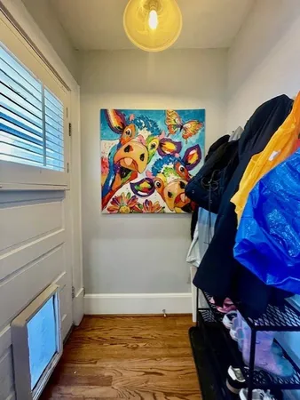 a view of a room with wooden floor and window