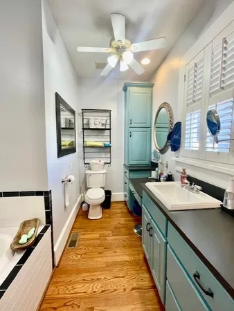 a spacious bathroom with a double vanity sink and a mirror