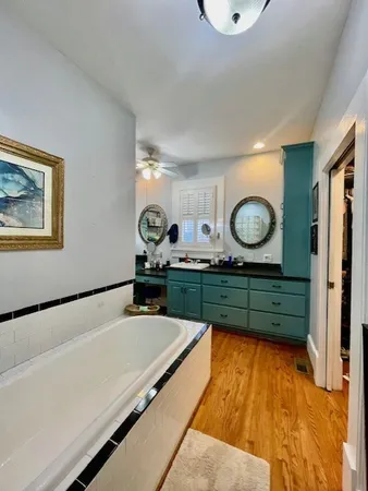 a room with two couches and painting on the wall