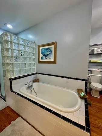 a bath tub sitting in a bathroom next to a window