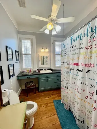 a bathroom with a sink mirror vanity and toilet