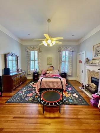 a bed room with a bed mirror and couch