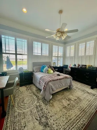 a spacious bedroom with a large bed and a chandelier