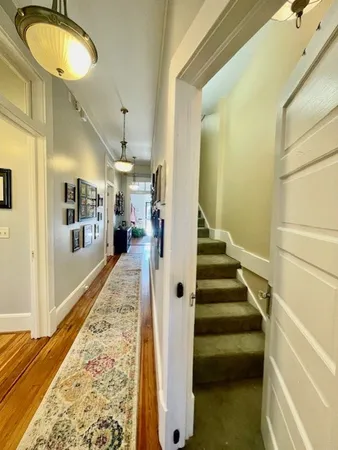 a view of entryway with wooden floor and a front door