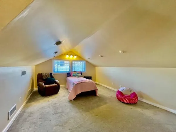 a bedroom with furniture and a wooden floor