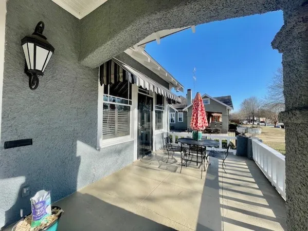 a dining room with furniture and a window