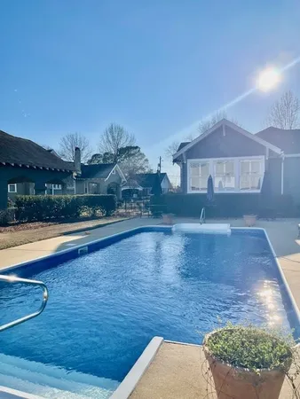 a view of a swimming pool and a yard