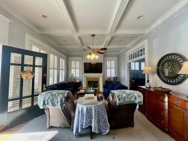 a living room with furniture a large window and a fireplace