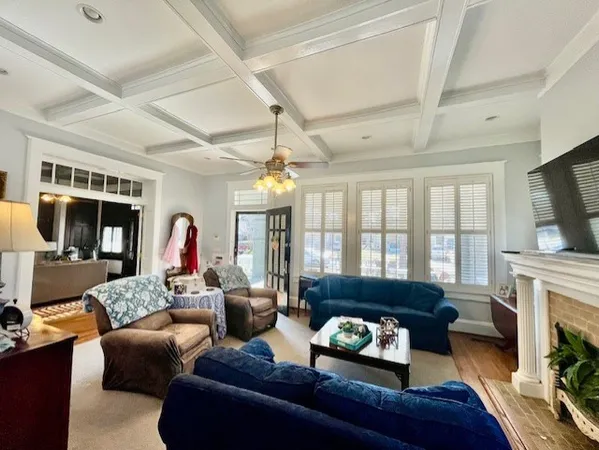 a living room with furniture a fireplace and a flat screen tv