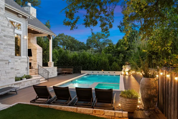 a outdoor living space with furniture a fireplace and a flat screen tv